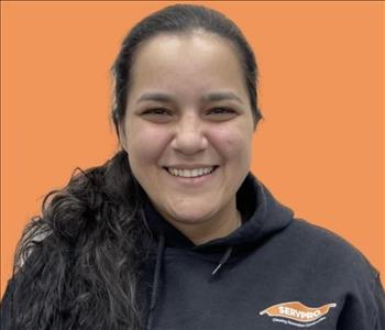 woman in front of orange wall