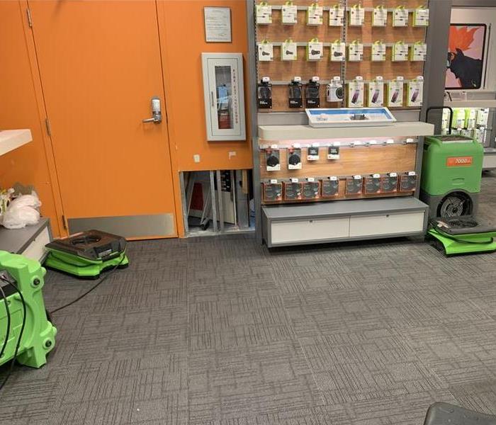 Green air movers on a grey carpet. 