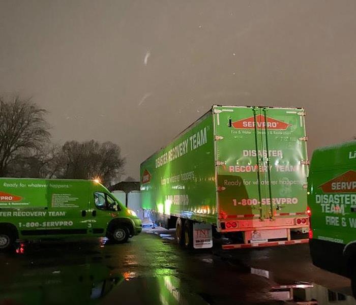 SERVPRO vans parked outside while it's snowing.