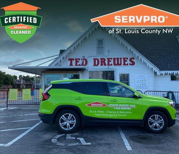 Green SERVPRO SUV parked in front of Ted Drewes.